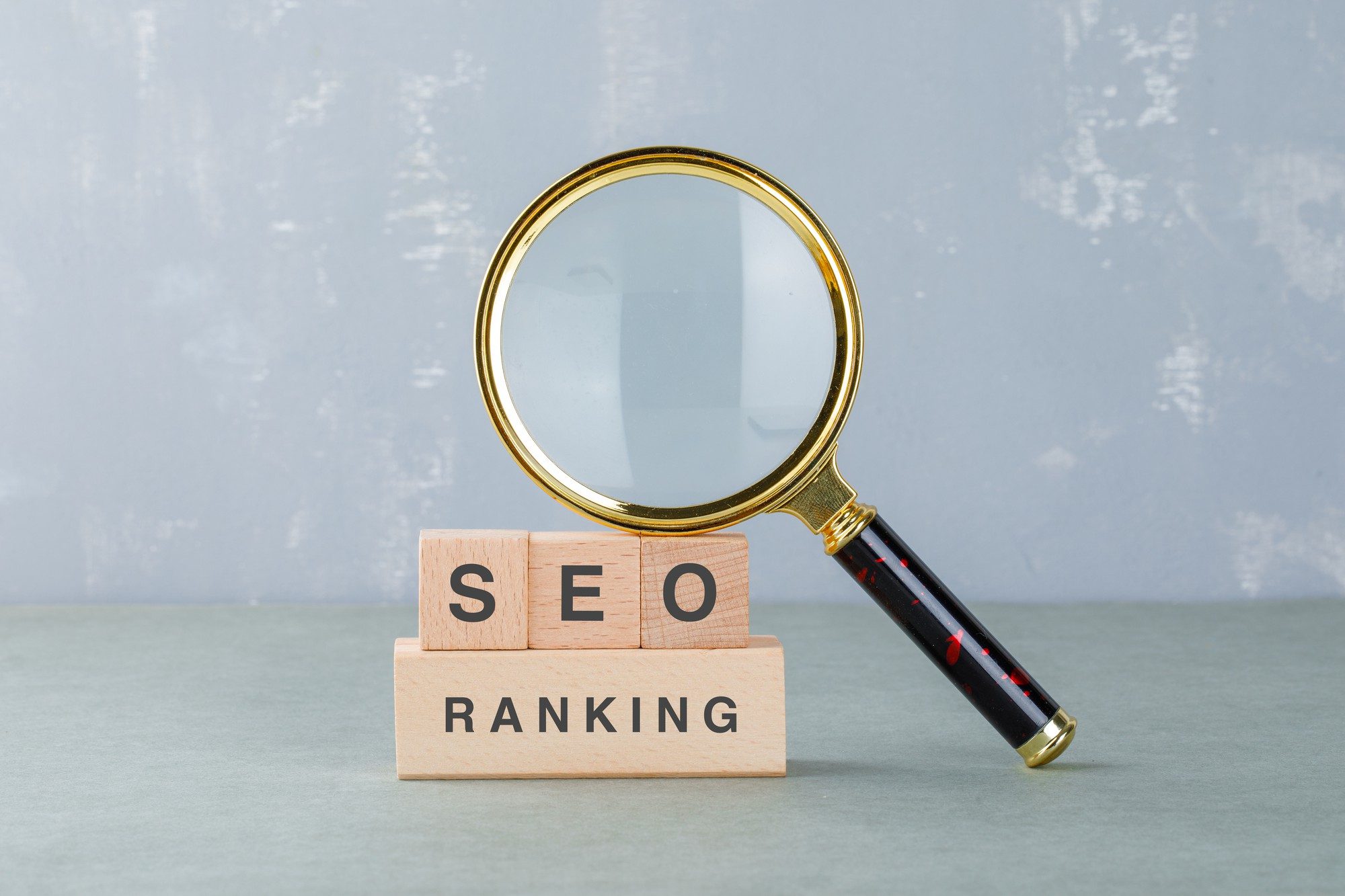 SEO ranking blocks with magnifying glass symbolizing search optimization in acupuncture marketing services